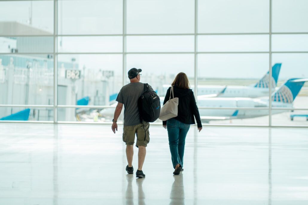 a man and a woman walking - airport security and gun in airport charges